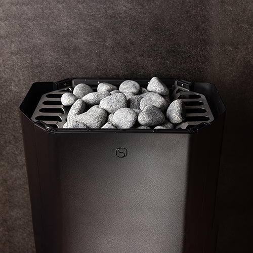 Saunum front-top detail of Air Perfect heater filled with rounded stones.