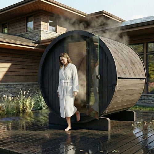 SaunaLife E7B black barrel sauna on a wet patio with a bather at the entrance.