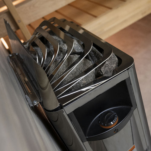 Close-up of stones, top guard and side control on a Harvia The Wall black heater.