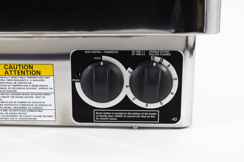Close-up of the Harvia KIP heater's two built-in control dials and warning labels.