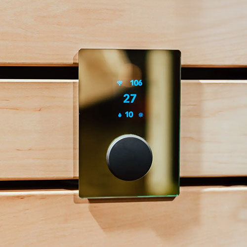 HUUM uKU gold control on wood paneling with display lit.