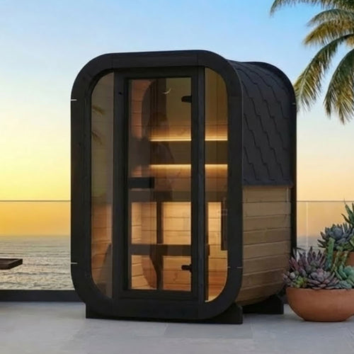 SaunaLife CL3G natural-wood compact cube sauna with illuminated interior beside a seaside patio.