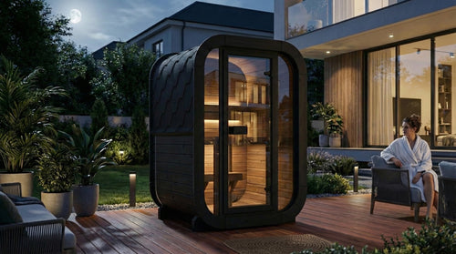 SaunaLife CL3GB black compact cube sauna on a garden patio at dusk.