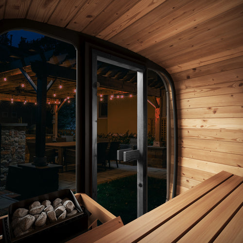 SaunaLife CL4GB cube sauna interior looking through glass front at night.