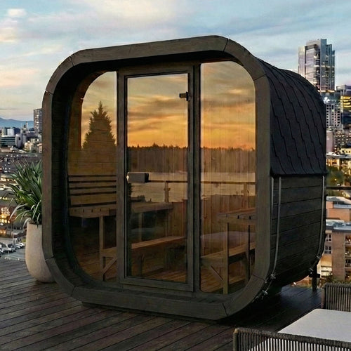 SaunaLife CL7GB black cube sauna on a city rooftop terrace at sunset.
