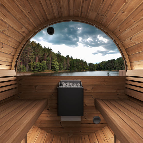 SaunaLife E6W barrel sauna interior with facing benches, heater and semicircular rear window overlooking a lake.