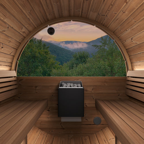 SaunaLife E8WB barrel sauna interior with facing benches, heater and semicircular rear window overlooking mountains.