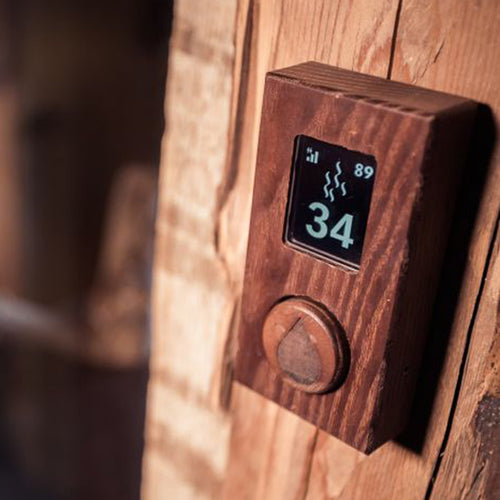 HUUM uKU wood control mounted on timber with temperature display lit.