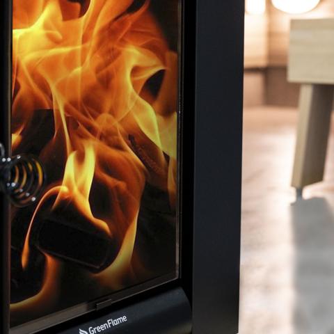 Close-up of the glowing fire behind a Harvia Linear 22 GreenFlame ES stove door.